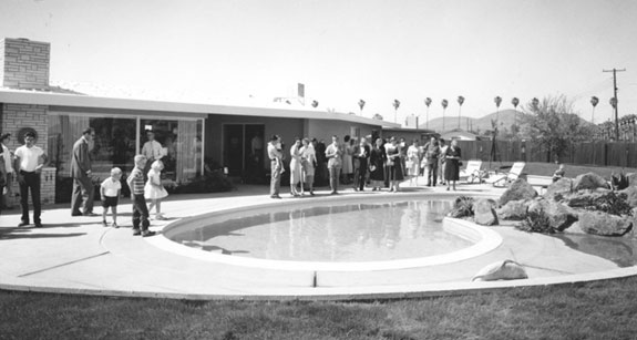 People gathered beside a backyard pool at a house in Maryvale. Photo: Courtesy of John F. Long Properties LLLP, The Frontier of Leisure